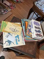 Overview of stack showing multiple books and booklets on table