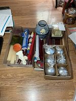 two boxes showing assorted candles of various types and colors