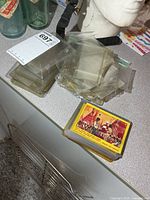 Stack of RCMP cards beside pile of plastic sleeves and top-loaders