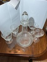 Full view of decanter with stopper and four glasses