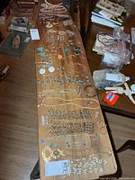 Overview of table with full assortment of necklaces, bracelets, earrings, brooches, pendants, ring