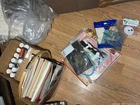 Overview showing magazines, paint bottles, embroidery supplies and additional craft items