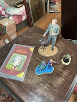 Overall lot showing all three figurines on table