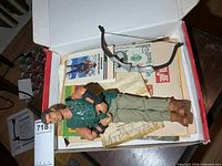 Figure, accessories and paper items inside box