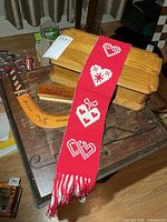 Wood box with lid, boomerang, metal hanger rod, woven wall hanging draped