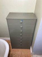 Front view of tall painted wood chest with eight drawers