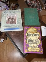 Three books laid out: Destinies, green hardcover, NWMP Law and Order