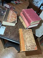 Five books on small table showing bindings and covers