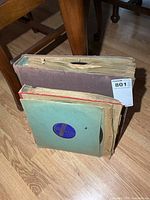 Two binders of records standing upright with loose record sleeves visible
