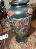 Vase front showing peacock relief and flower medallions