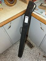 Black zip pool cue case standing upright