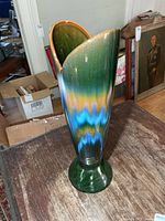 Front view of tall multicolour ceramic vase on pedestal base
