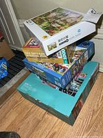 Stack of five puzzle boxes showing variety and sizes