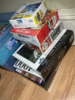 Stack of six puzzle boxes showing titles and sizes