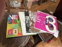 Stack of six vinyl records on table