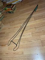 Full view of rug beater on floor