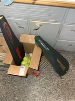 Box with Wilson covers and tennis balls visible