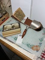 Viewer and stack of stereograph cards on countertop