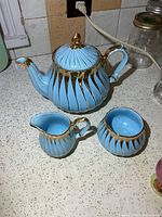 Teapot, creamer and sugar bowl grouped on countertop