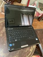 Open Toshiba Satellite laptop showing screen and keyboard