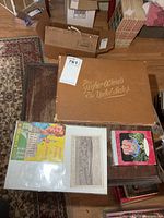 Grouped shot showing Higher Officials book, Marx booklet, postcard, and boxed ornament