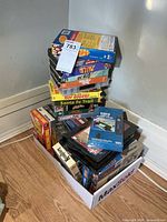 Box of assorted VHS tapes and cleaning tape