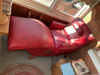 Top view of entire red vinyl recliner fully extended