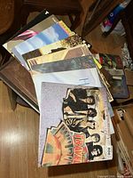 Stack of eight LP records fanned out on a table