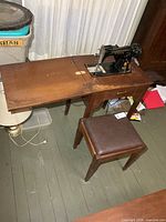 Overhead view showing Singer machine mounted in cabinet with bench