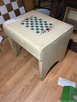 Full view of stool showing painted design and structure