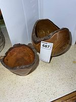 Both wooden bowls side by side showing size difference, bark rims, grain
