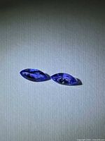 Pair of marquise deep blue tanzanites on white background