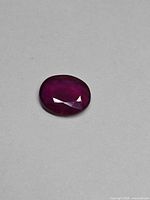Top view of oval ruby showing color and cut