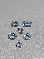 All six aquamarines arranged to show variety of cuts and clarity