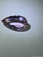 Front view of faceted pear-cut amethyst
