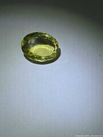 Top view of oval lemon citrine showing faceted crown and color