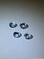 Top view of four round aquamarines