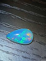 Top view pear cabochon opal showing multicolored play of color
