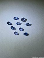 Multiple pear-cut tanzanite gemstones shown to illustrate color and cut