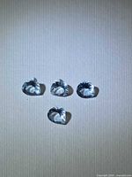 Four pear-cut aquamarines grouped on light background