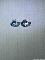 Two pear-cut aquamarines front view showing colour and cut