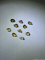 Group of 10 pear-cut yellow tanzanites on white background