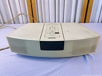 Top and front view of Bose Wave Radio showing attached power cord and overall condition