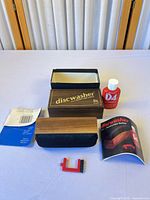 Full kit layout: pad, bottle, brush, box, manuals