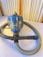 Entire vacuum with hose and wand visible