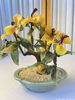 Front view of glass flower bonsai in ceramic pot