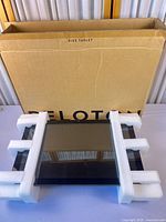 Front view of Peloton touchscreen with foam and box