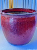Full view of red glazed ceramic planter exterior