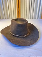 Front angled view of brown felt cowboy hat showing crown shape and brim