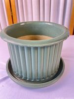 Overall view of ribbed seafoam planter with saucer